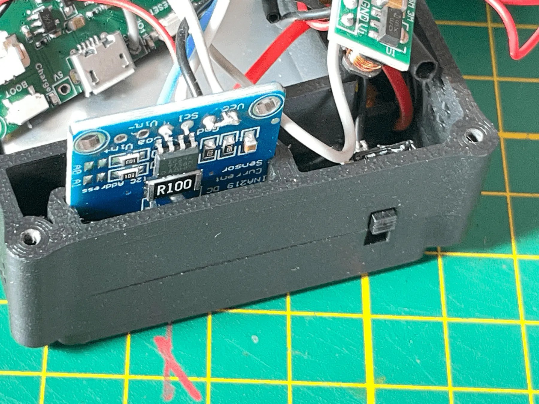 Sliding the INA219 board into the housing slots