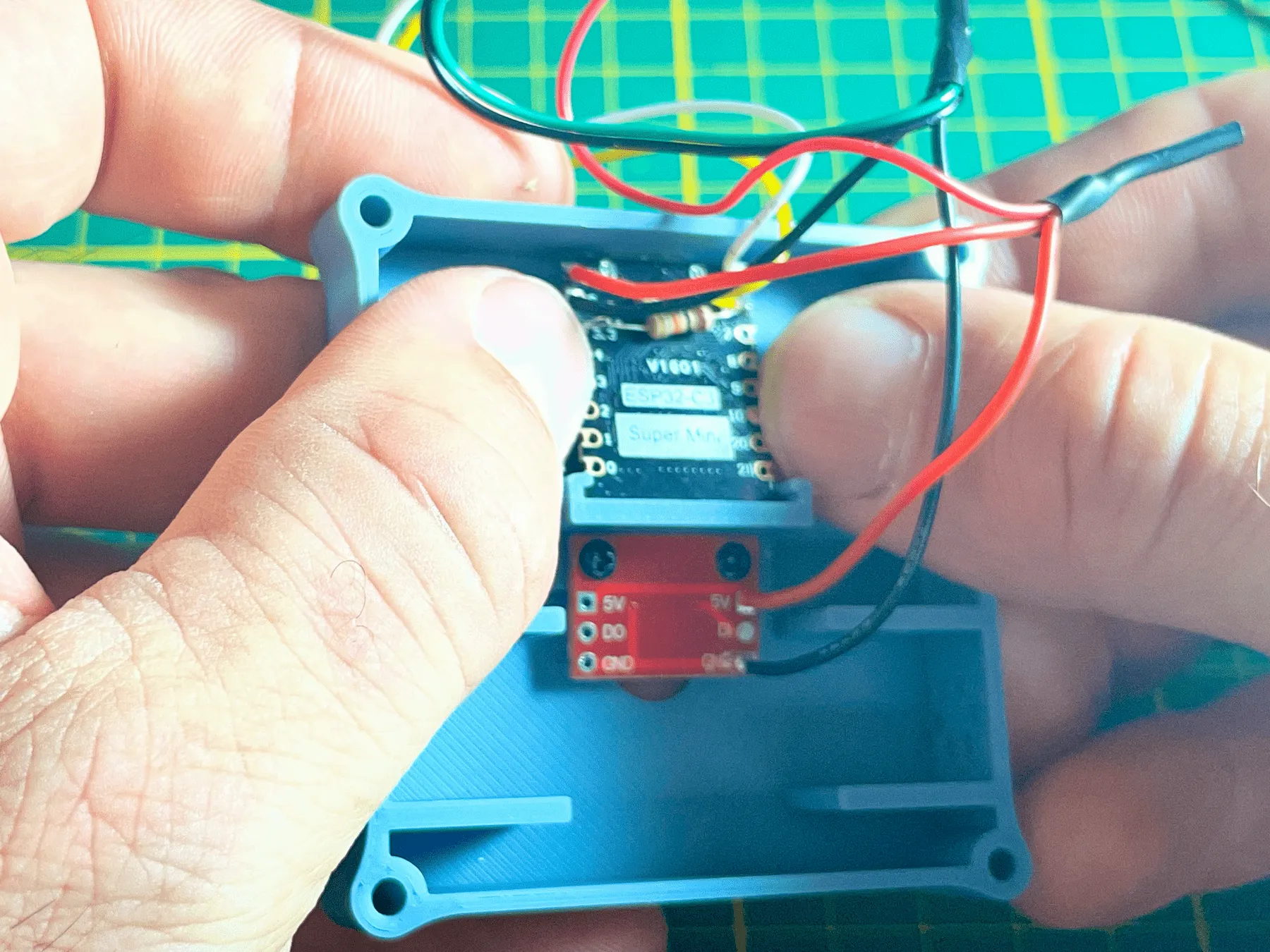 ESP32-C3 SuperMini seated with the USB connector in the enclosure opening